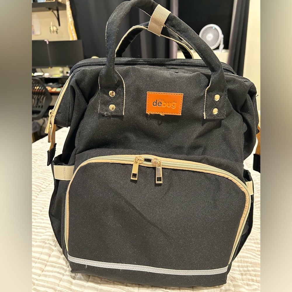 Debug diaper bag with changing station.